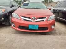 A picture of Red Toyota Corolla for sale tokunbo standard