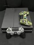A picture of Ps4 fat 2 controllers 9 games inside