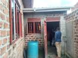 A picture of A Semi finished House in a fence is up for