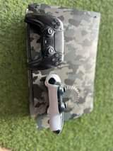 A picture of Ps5 2 controllers customized with 10gamez installed