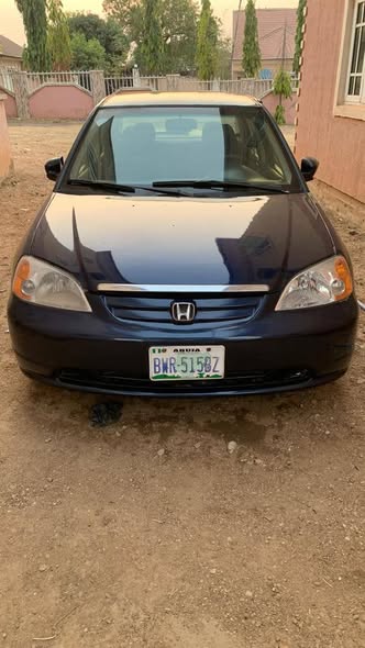 A picture of distress 2003 Honda civic with good engine gear going for