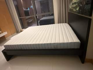 A picture of IKEA Bedframe black brown Vestmarka sprung mattress