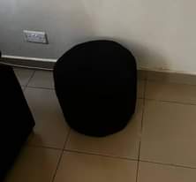 A picture of 3 seaters sofa and puff