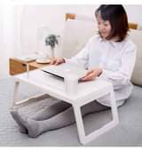 A picture of Foldable and portable laptop desk or WhatsApp 0784884323