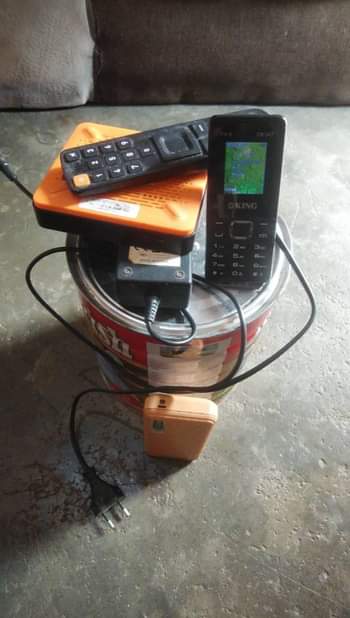 A picture of Startimes deco remote charger power bank and phone