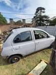 A picture of Nissan micra 2006 striped with paper