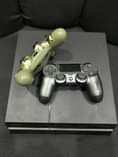 A picture of Ps4 fat 2 controllers 9 games inside