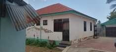 A picture of NYUMBA TATU KWENYE ENEO MOJA ZINAUZWA NA BANK KIGAMBONI MAGOGONI