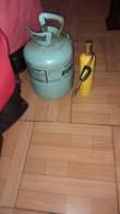 A picture of Container with some fridge gas burner almost full