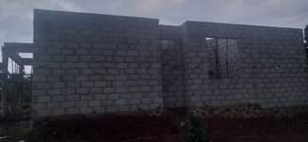 A picture of land and house for sale
