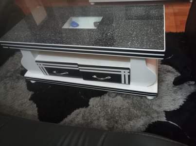 A picture of 5 seater original leather pure black 985k Tv stand 265k