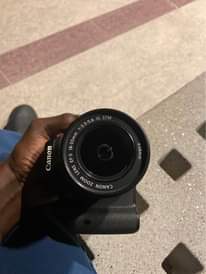 A picture of Canon 750D with two batteries and to charge