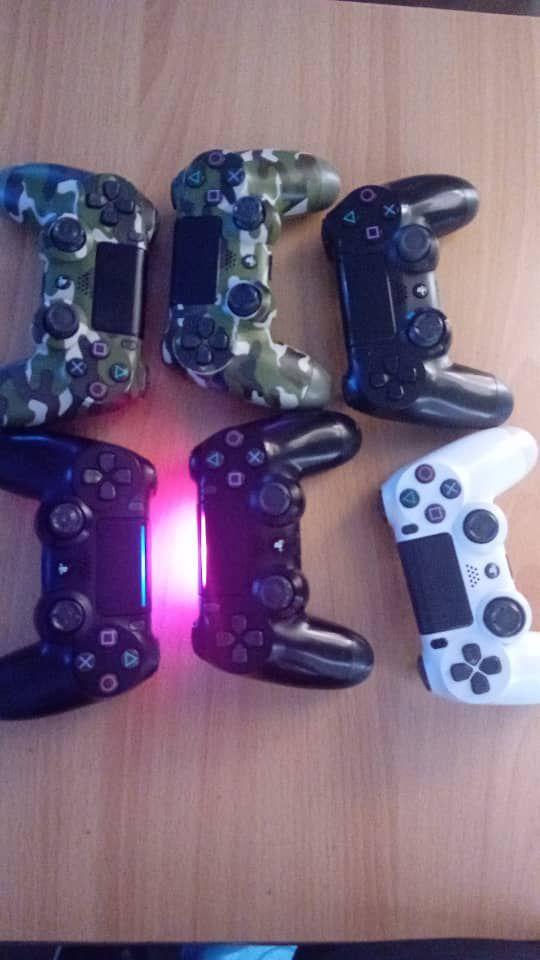 A picture of 3 Ps4 consoles 8 games each 2 original UK used
