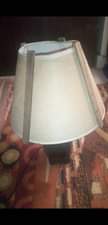 A picture of bed side lamp and center carpet