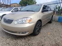 A picture of GOLD SUPER SHARP COROLLA 2006 IN A STANDARD GRADE AC