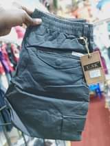 A picture of Kaki cargo pants Price ugx 65 000 Call Whatsapp me