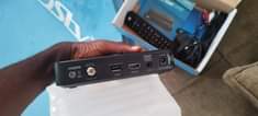 A picture of DSTV Decoder with complete accessories