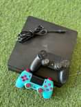 A picture of Ps4 slim 2 controller with games
