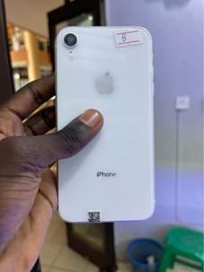 A picture of iPhone XR 64gb clean no cracks 700k BM WhatsApp or