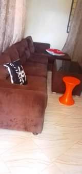 A picture of friji kubwa na sofa pamoja na meza