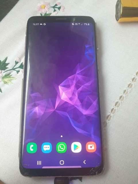 A picture of Samsung galaxy s9 with dot little greenish display and invisible