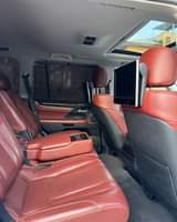 A picture of 2016 Lexus LX570 in pearl white on red interior