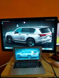 A picture of MacBook Air 2015 with Apple LED cinema display 27 