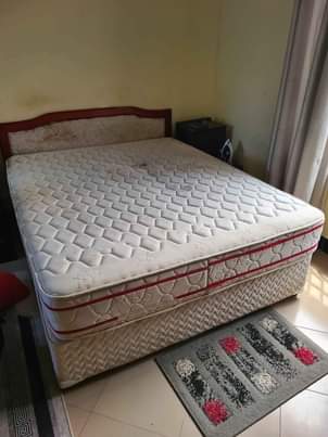 A picture of Bed with bedsides mninga