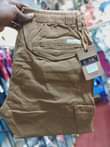 A picture of Kaki cargo pants Price ugx 65 000 Call Whatsapp me
