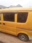 A picture of Susuki Mini Bus currently plying the road with gear that