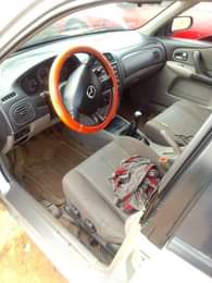 A picture of Mazda 323 for sale direct Belgium 3months used everything is
