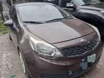 A picture of 2015 COMPANY USED KIA RIO MANUAL DRIVE LOW MILEAGE FIRST