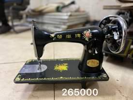 A picture of Sewing machines with their stands