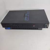 A picture of playstation 2 with 2 controllers and cables plus 10 games