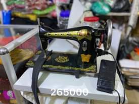 A picture of Sewing machines with their stands