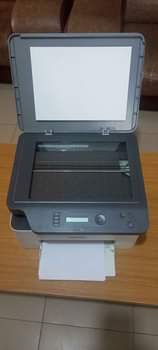 A picture of Three 3 in One Hp Laser MFP 135a printer .