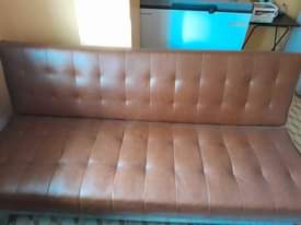 A picture of BROWN LEATHER SLEEPER COUCH IN A GOOD CONDITION
