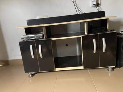 A picture of TV stand available and glass center table both