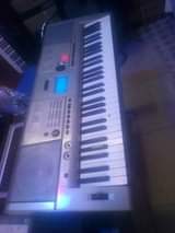 A picture of Piano drumsets keyboards speakers and microphones..
