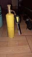 A picture of Container with some fridge gas burner almost full