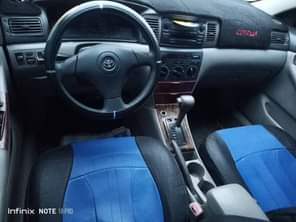 A picture of Toyota Corolla with sound engine and gear location is uyo