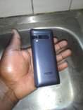 A picture of Original Tecno 528 button phone with the receipt