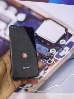 A picture of Honor 8 lite with small dot and crack