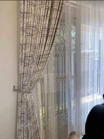 A picture of Curtains nets blinds and rods