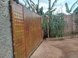 A picture of A Semi finished House in a fence is up for