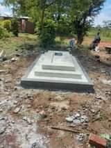 A picture of Grave finishing head stones plaques with writings and photoes