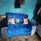 A picture of 2 seater sofas with pillows on quick sale