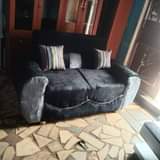 A picture of 2 seater sofas with pillows on quick sale