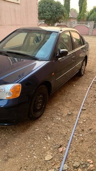 A picture of distress 2003 Honda civic with good engine gear going for