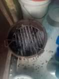 A picture of Flampen charcoal stove a bucket